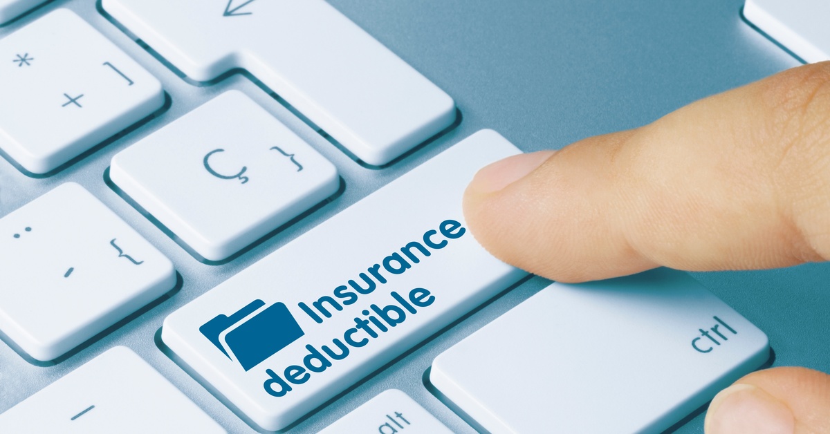 Close-up of a finger about to press a button on a keyboard marked "Insurance Deductible." It also has a file symbol.